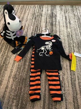 Carters 2 pair Dino skeleton pajama set and stuffed Dino. Size 18 months